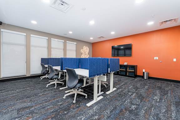 A conference room with blue dividers and chairs.