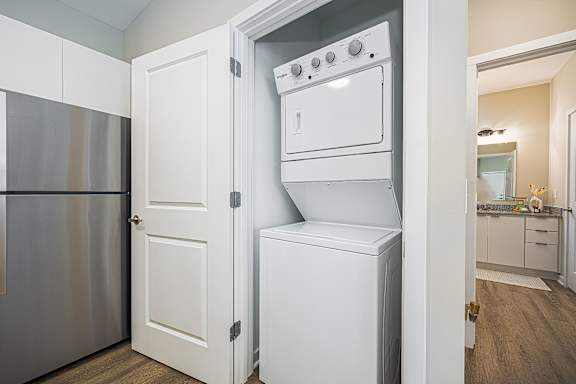 a laundry room with a washer and dryer and a refrigerator