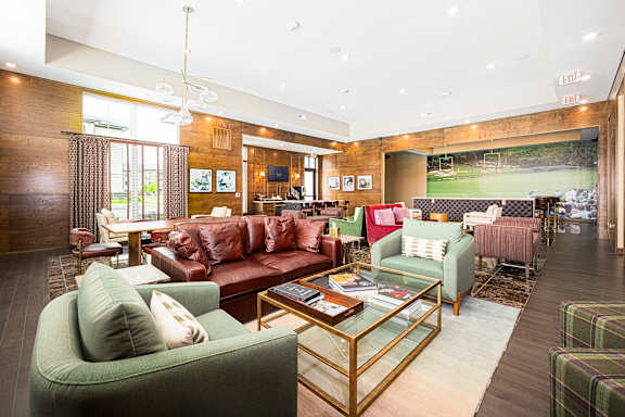 a living room with couches and chairs and a table