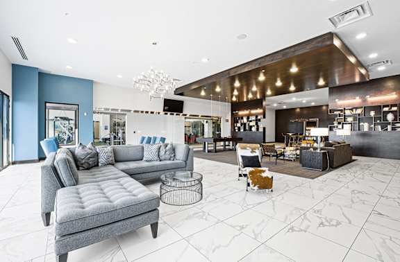 A modern living room with a grey sofa and a coffee table.