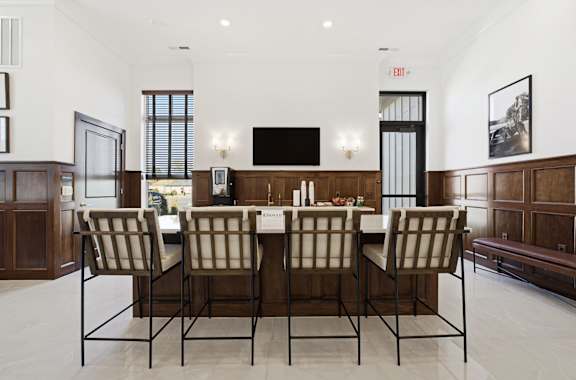 A dining room with a long table and chairs.