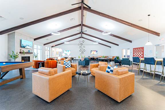 A large room with a pool table and couches.