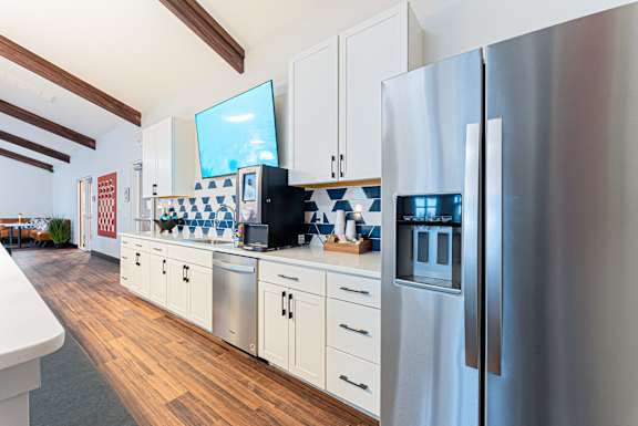 A modern kitchen with a refrigerator on the right.