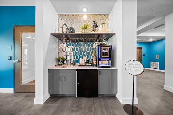 A small bar area with a sign that says "So happy we have refills".