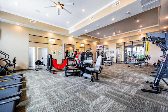 a gym with weights and cardio equipment at the flats