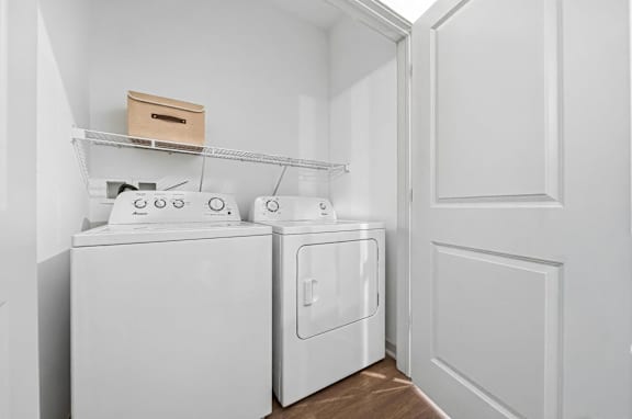A white washing machine and dryer in a laundry room.