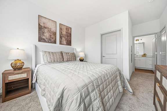 A bedroom with a large bed and two pictures on the wall.