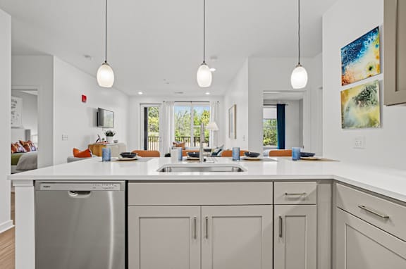 A modern kitchen with a large island and stainless steel appliances.