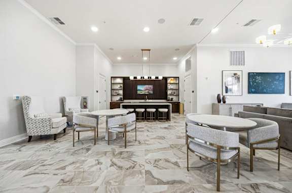 A modern living room with a white table and chairs.