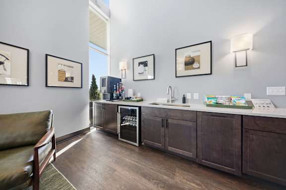 A kitchen with a refrigerator, oven, and sink.