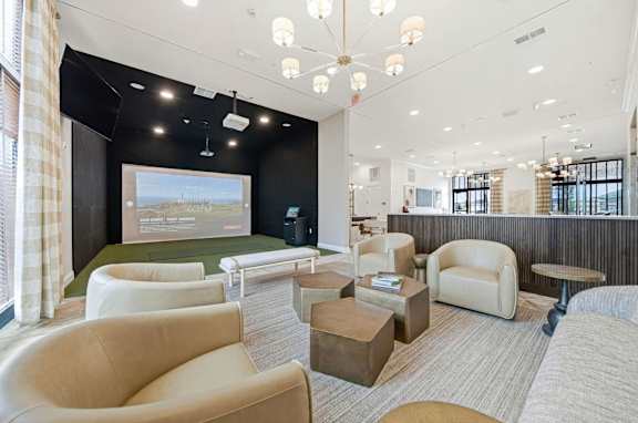 A conference room with a screen and chairs.