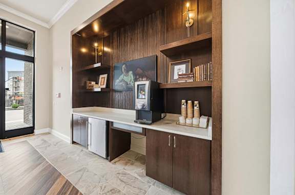 A modern kitchen with a wooden shelf and a counter.
