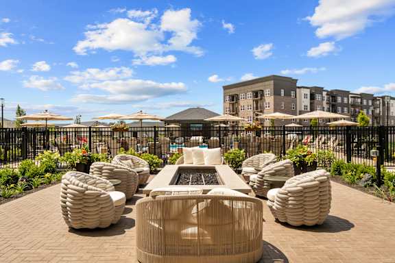 A modern outdoor seating area with a fountain in the middle.
