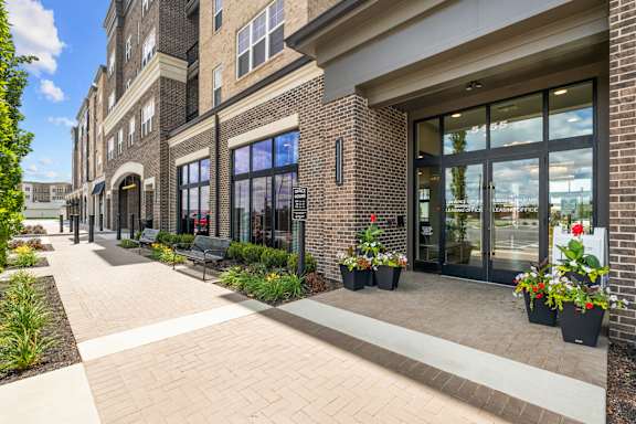 A building with a brick facade and a glass door entrance.