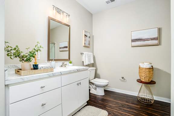 a bathroom with a toilet and a sink and a mirror