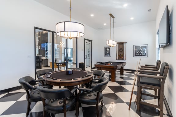 a dining room with a table and chairs and a pool table