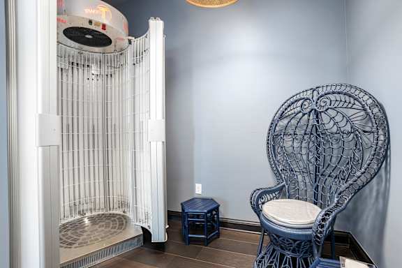 a chair and a crib in a room with a radiator