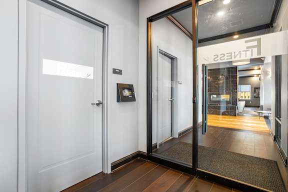 a view of a lobby with white walls and glass doors