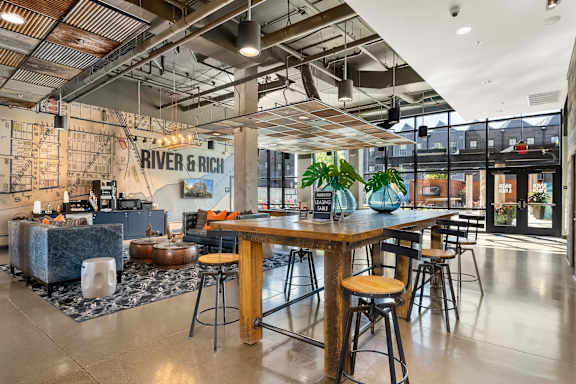 A modern dining area with a wooden table and chairs.