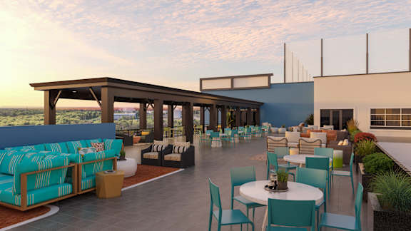 A patio with a table and chairs is set up on a rooftop.