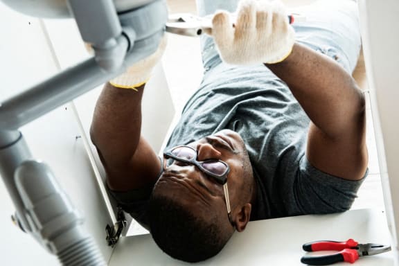 a man laying on the floor next to a dentist machine