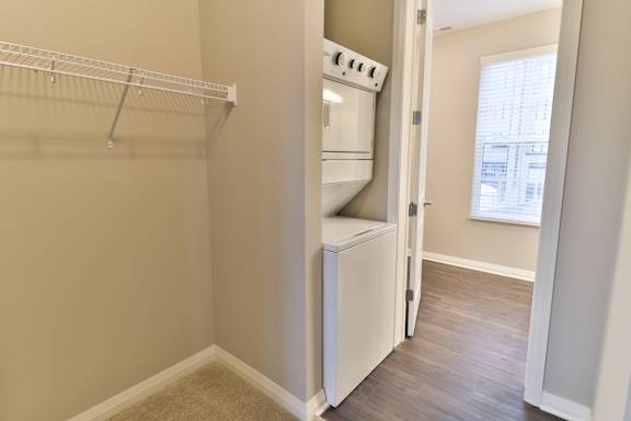 A small kitchen with a white oven and a white fridge.