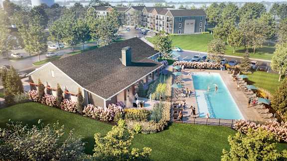 A large building with a pool in front of it.
