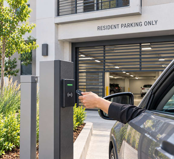 A person is opening a parking meter with a keypad.