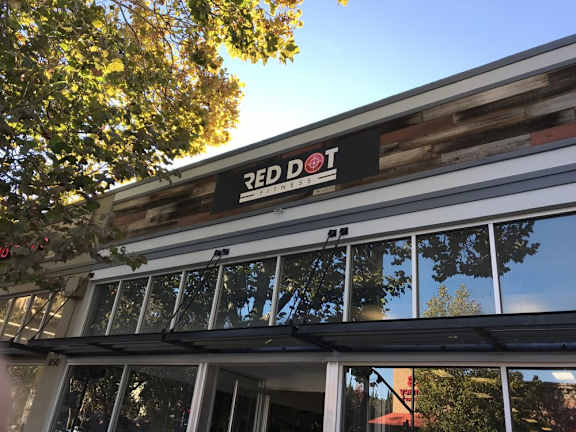 the front of a building with a red dot sign