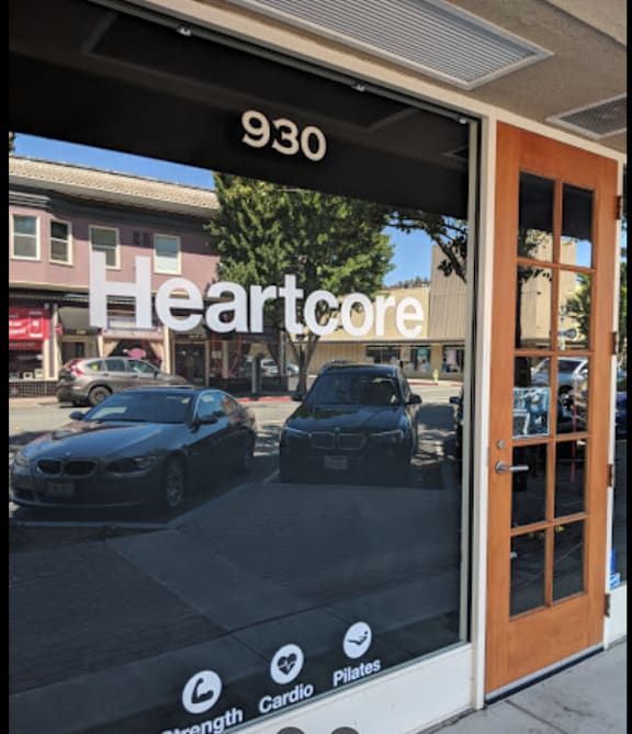 a dealership door with cars parked in front of it