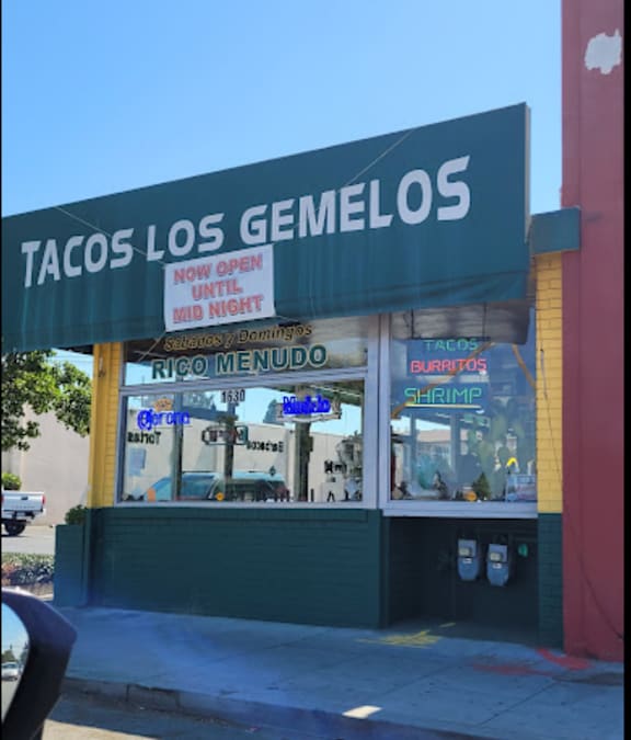 the facade of a tacos restaurant on a city street