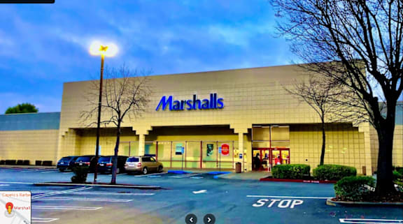 a marshalls store in a parking lot with cars parked in front