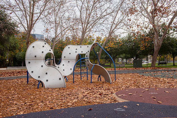 A playground with a slide and a climbing structure.