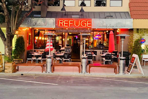 a restaurant with tables and chairs outside of it