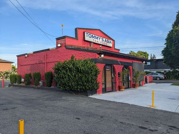 a red building with a tommy sushi sign on it