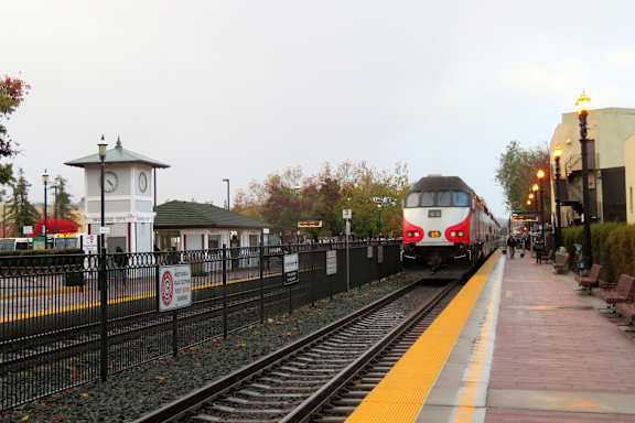 a train pulling into a train station on the tracks