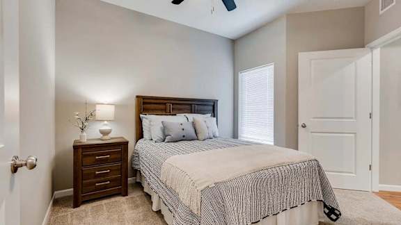 a bedroom with a bed and a closet. Circle Pines, MN Lexington Lofts