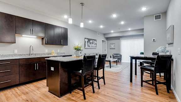 a kitchen and dining room with a table and chairs. Circle Pines, MN Lexington Lofts