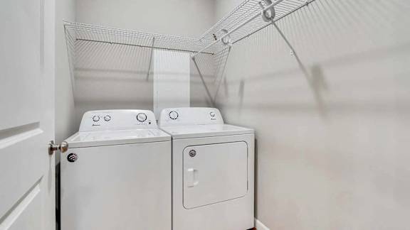 a washer and dryer in a laundry room with white walls. Circle Pines, MN Lexington Lofts