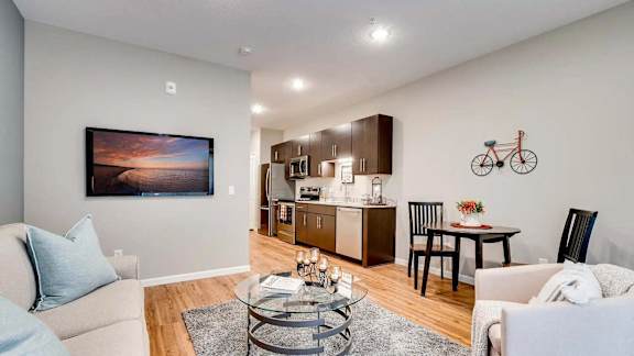 a living room and kitchen with a couch and a table. Circle Pines, MN Lexington Lofts