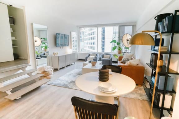 a living room with hardwood floors and a round table and a couch
