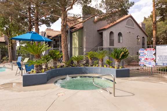 A pool with a hot tub in the middle of it.