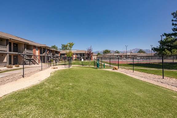 A grassy area in front of apartment buildings.