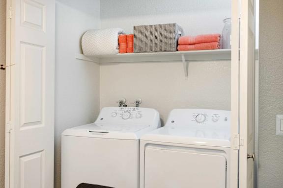 A small laundry room with a washer and dryer.