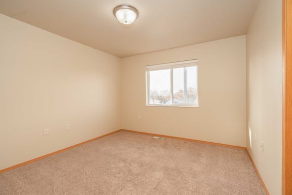Bedroom with window at Benson Village Townhomes Apartments, Sioux Falls, SD