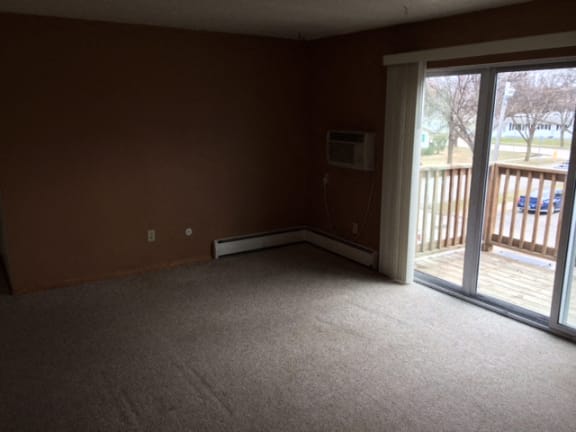 Living Room With Balcony at Southern Manor Apartments, Grand Forks, North Dakota