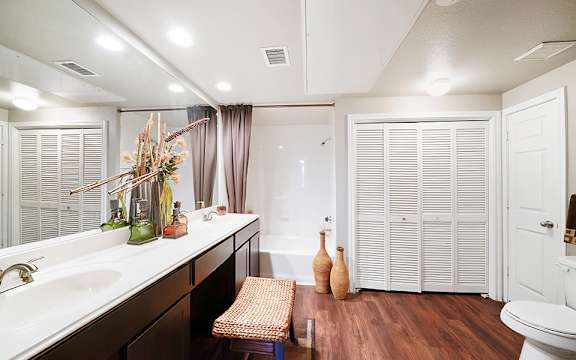 A bathroom with a white sink and a white toilet.