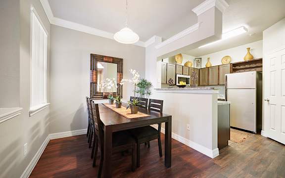 A kitchen with a table and chairs in the middle of the room.