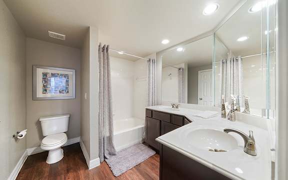 A bathroom with a white toilet, a white sink, and a white bathtub.