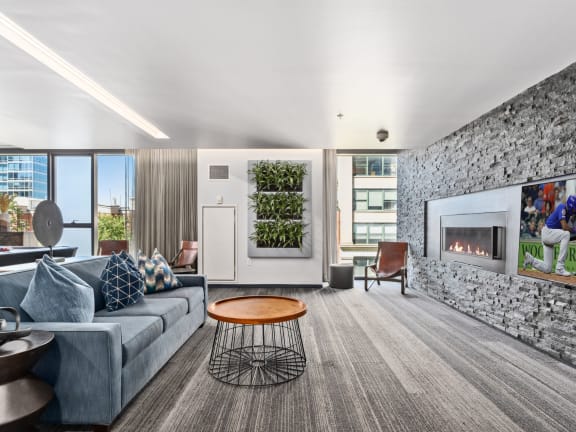 a living room with a gray couch and a fireplace at One 333, Chicago, Illinois, 60605